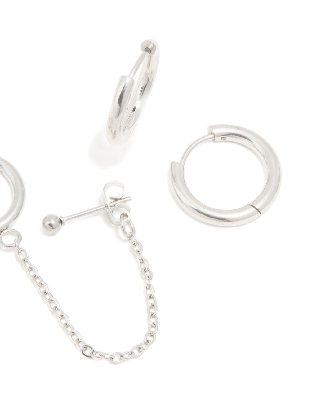 Crafted from waterproof stainless steel, these chain and huggie earrings in a 3-pack feature stud closure in silver finish post detail view