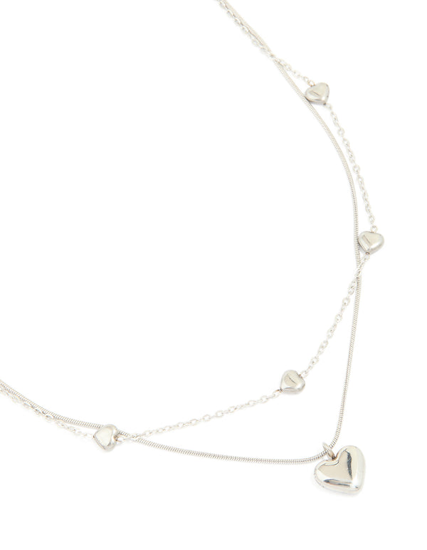 Showcasing a waterproof stainless steel multi heart charm layered necklace in silver close up view