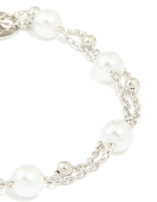 Crafted from waterproof stainless steel pearl and ball layered bracelet with white and silver details close up view