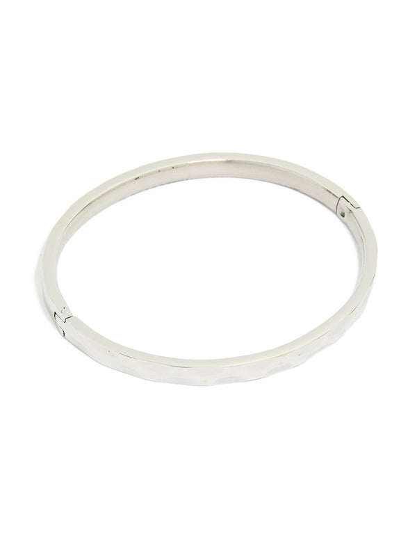 Featuring a waterproof stainless steel hammered hinged bangle in silver with statement design front view