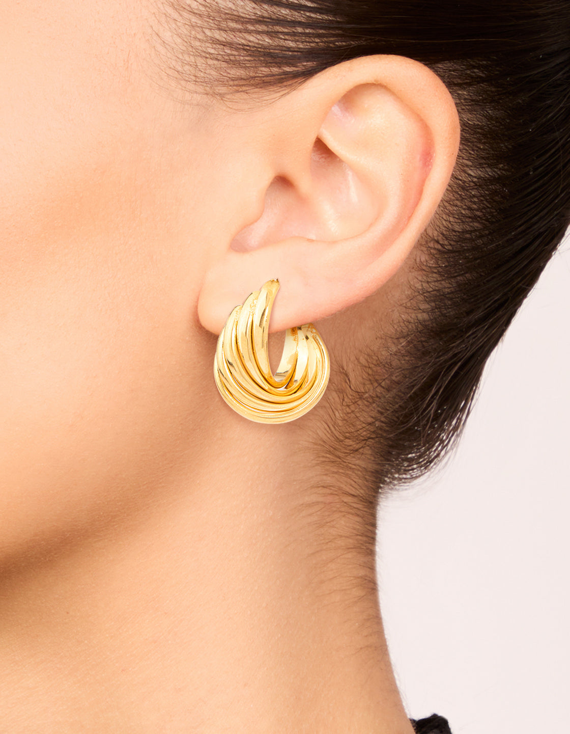 Featuring waterproof gold plated stainless steel 4-row twisted hoop earrings in statement style on ear view