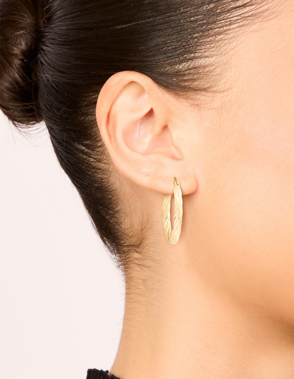 Featuring waterproof gold plated stainless steel large twisted hoop earrings with statement style on ear view