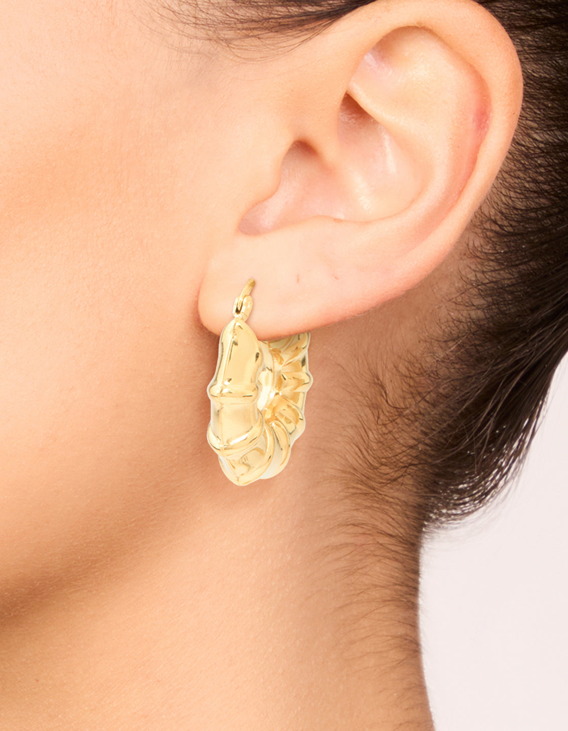 Crafted from waterproof gold plated stainless steel barrel detail hoop earrings on ear view