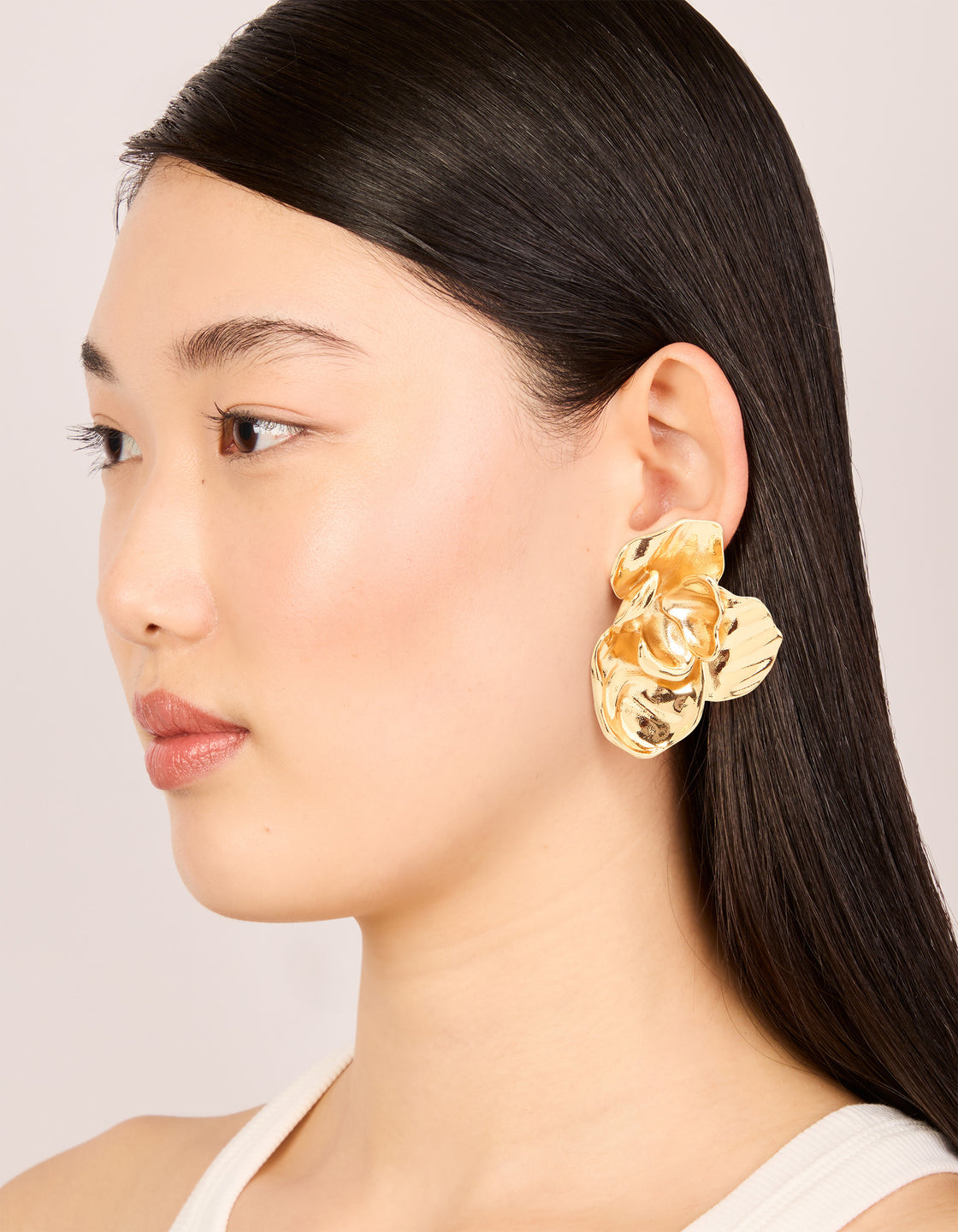 Beautifully crafted waterproof gold plated stainless steel twisted textured stud earrings on model view