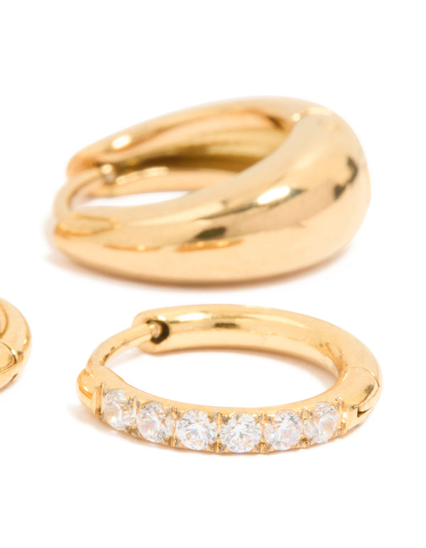 Highlighting waterproof cubic zirconia chubby huggie earrings set crafted from gold plated stainless steel with clear accents close up view