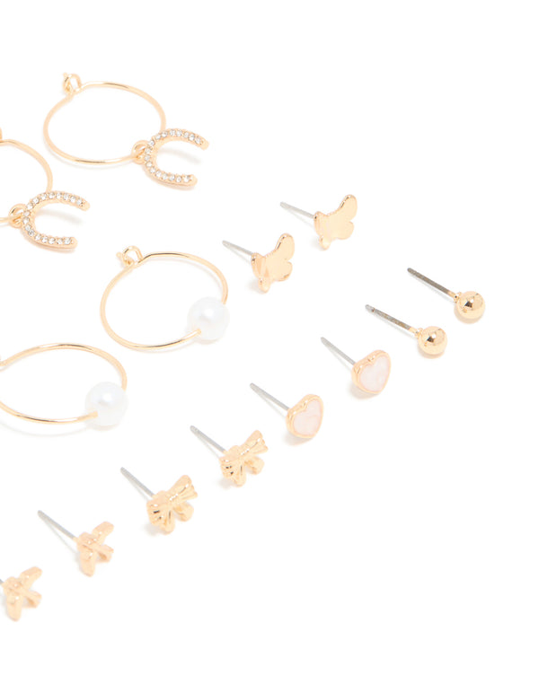 Discover this assorted 12-pack showcasing bow, butterfly, charm, and pearl accents in gold with white and ivory tones close up view
