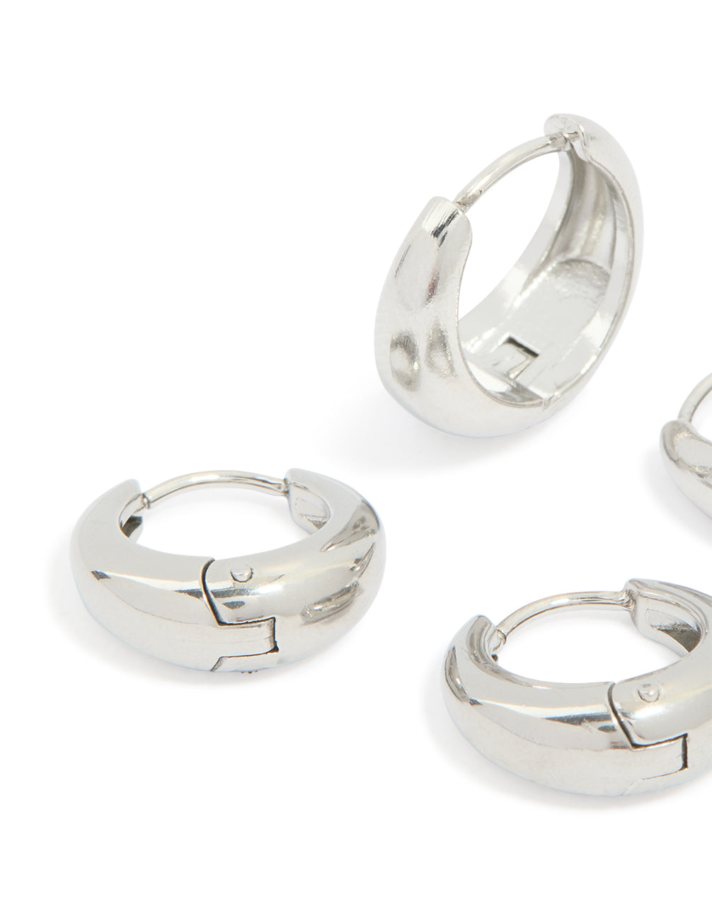 Designed with chunky waterproof stainless steel oval huggie earrings in silver, 2-pack close up view