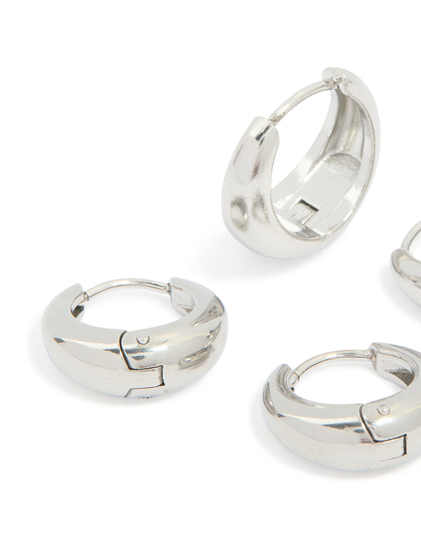 Designed with chunky waterproof stainless steel oval huggie earrings in silver, 2-pack close up view