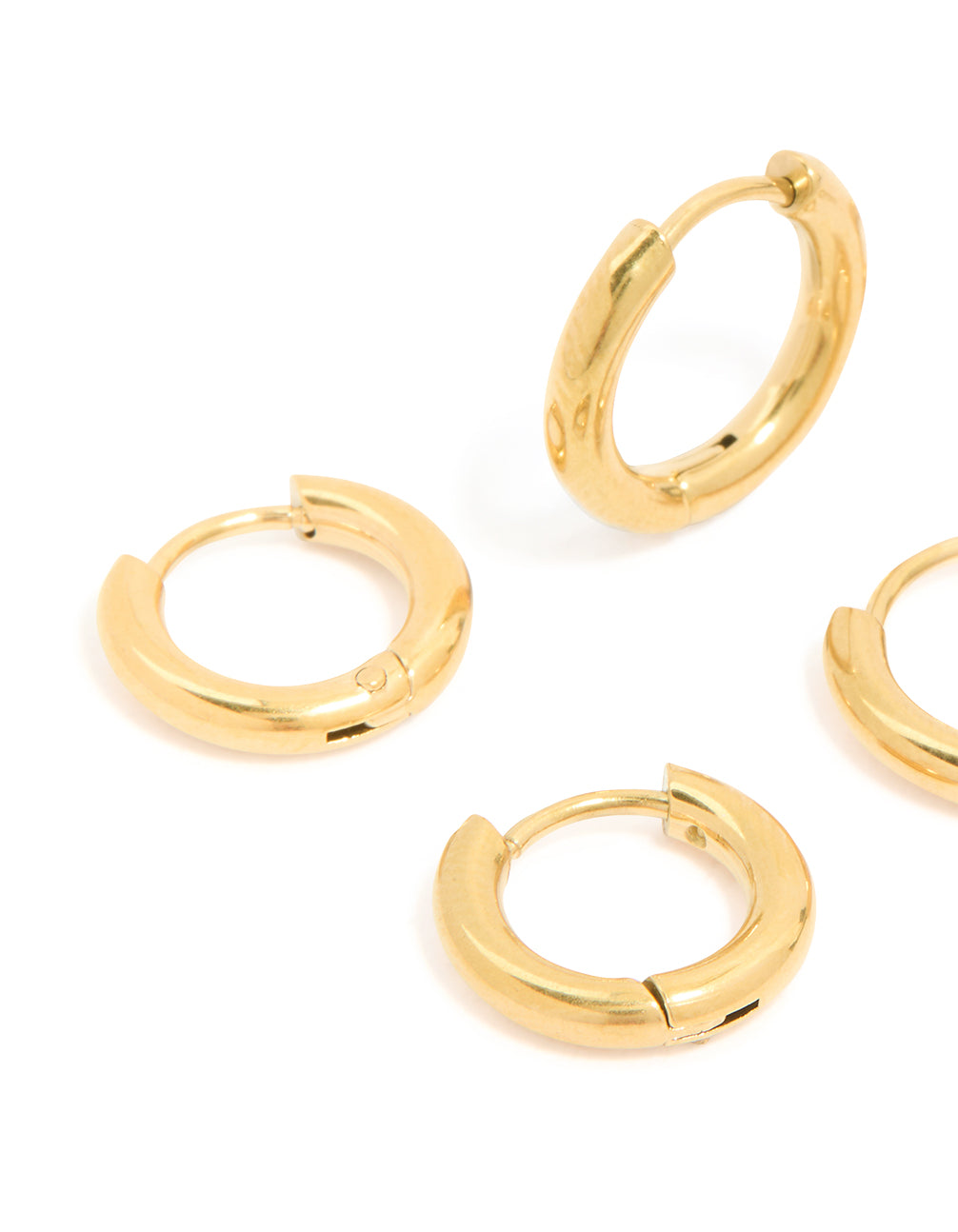 Highlighting small huggie earrings in a 3-pack, constructed from waterproof gold plated stainless steel close up view