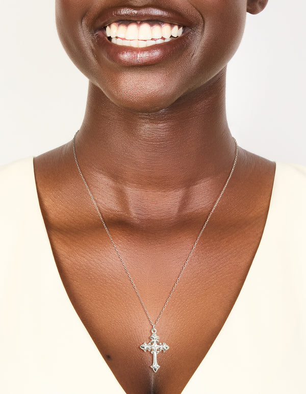 Showcasing a waterproof stainless steel gothic cross necklace in silver, statement style on neck view