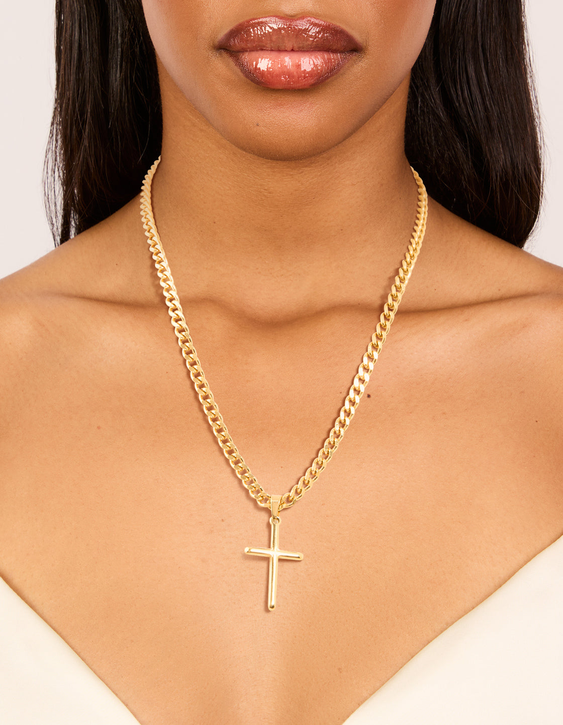 This waterproof gold plated stainless steel smooth plain cross pendant necklace shown on neck view