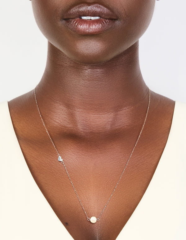 Crafted from sterling silver with heart and pearl accents on neck view
