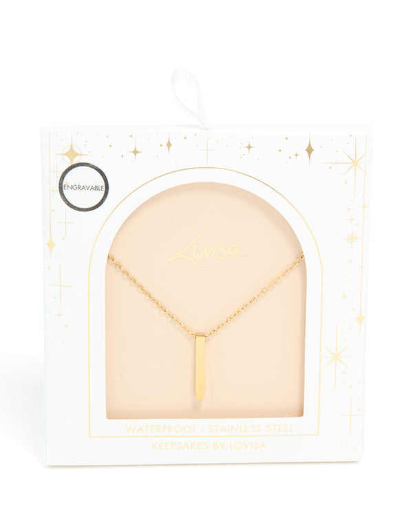 Featuring a waterproof bar pendant necklace in stainless steel with engravable pillar design and gold plated finish close up view
