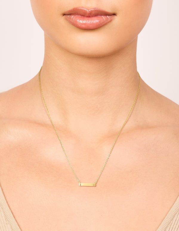 Showcasing a waterproof mini engravable bar necklace crafted from gold plated stainless steel with dainty style on neck view
