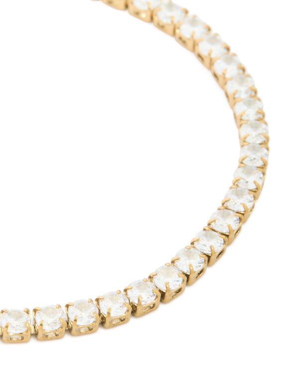 Detailed view of waterproof stainless steel tennis bracelet, crafted from gold plated material featuring clear cubic zirconia close up view