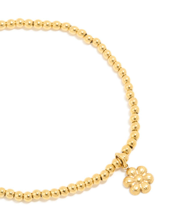 This waterproof gold plated stainless steel stretch bracelet with beads and floral close up view
