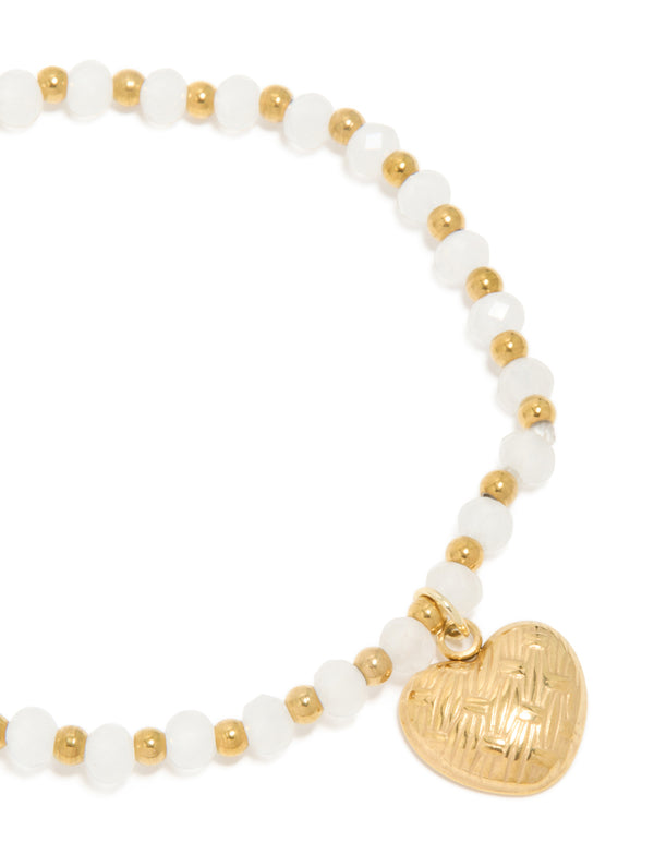 Detailed view of waterproof gold plated stainless steel beaded bracelet with textured heart and white semi precious stones close up view