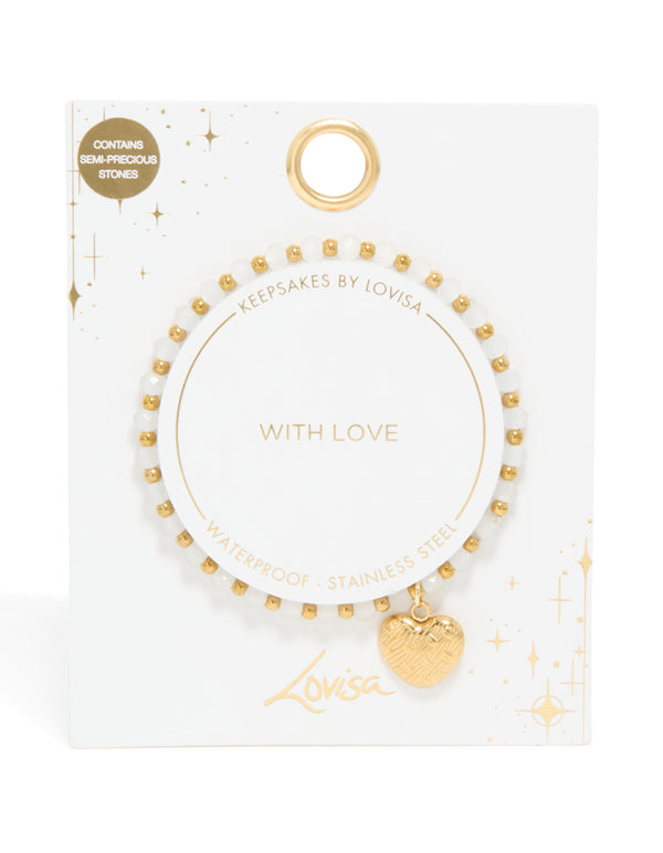 Detailed view of waterproof gold plated stainless steel beaded bracelet with textured heart and white semi precious stones close up view