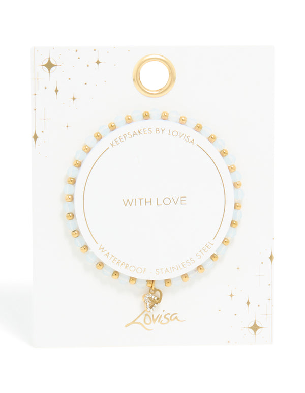 Designed with waterproof gold plated stainless steel, this beaded stretch bracelet features clear quartz stones and a dainty heart charm on model view