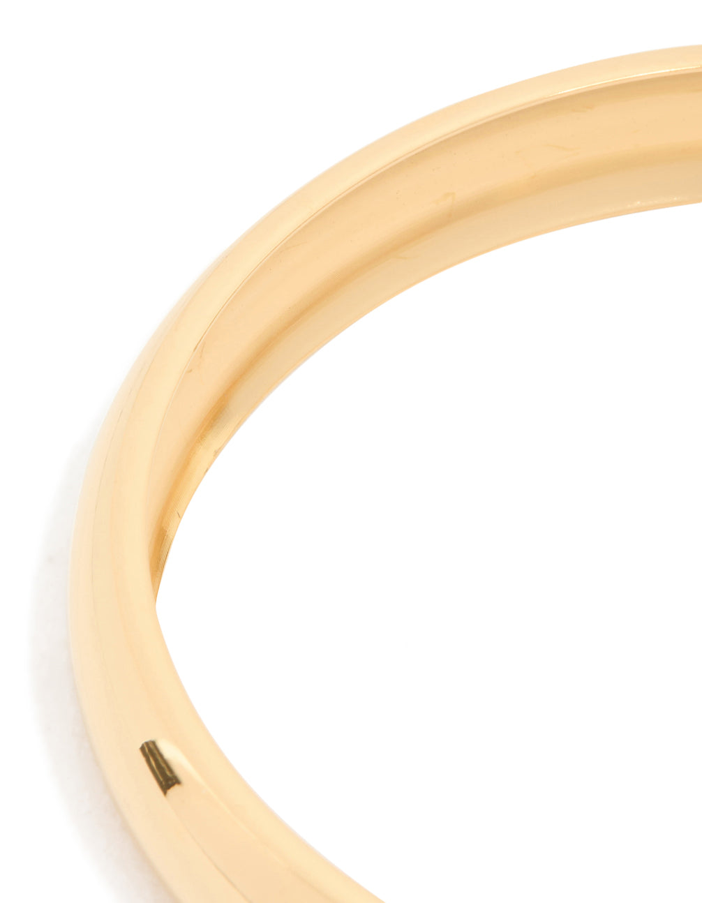 Crafted from waterproof gold plated stainless steel, this round smooth bangle in close up view