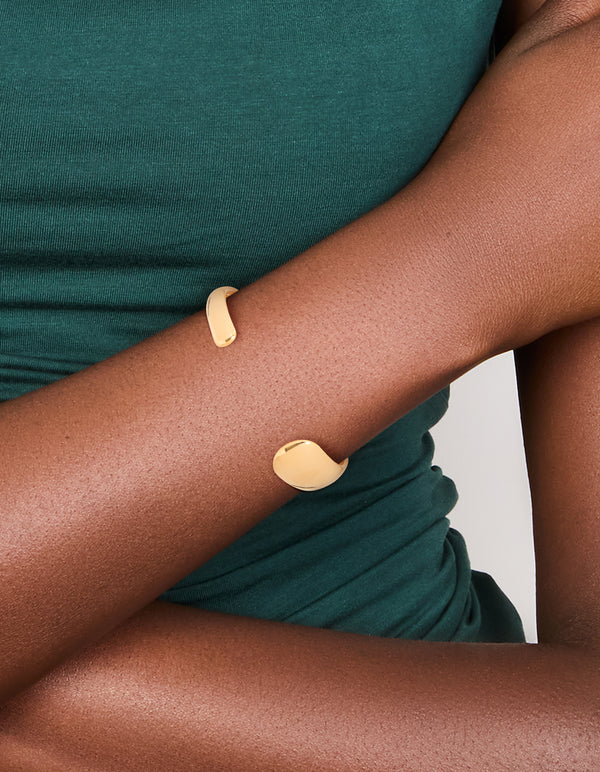Crafted from waterproof gold plated stainless steel, this asymmetrical wrist cuff in chunky design on wrist view