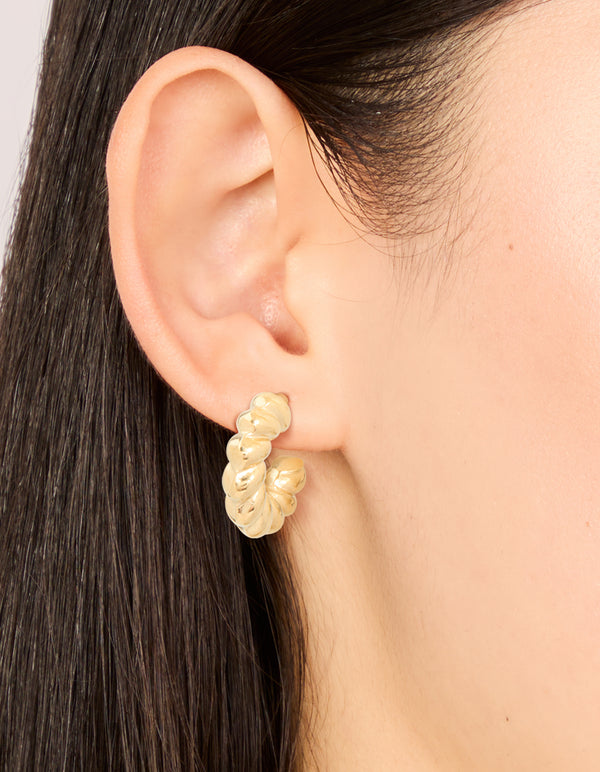 Crafted from waterproof gold plated stainless steel, these mini twisted open hoop earrings are styled on ear view