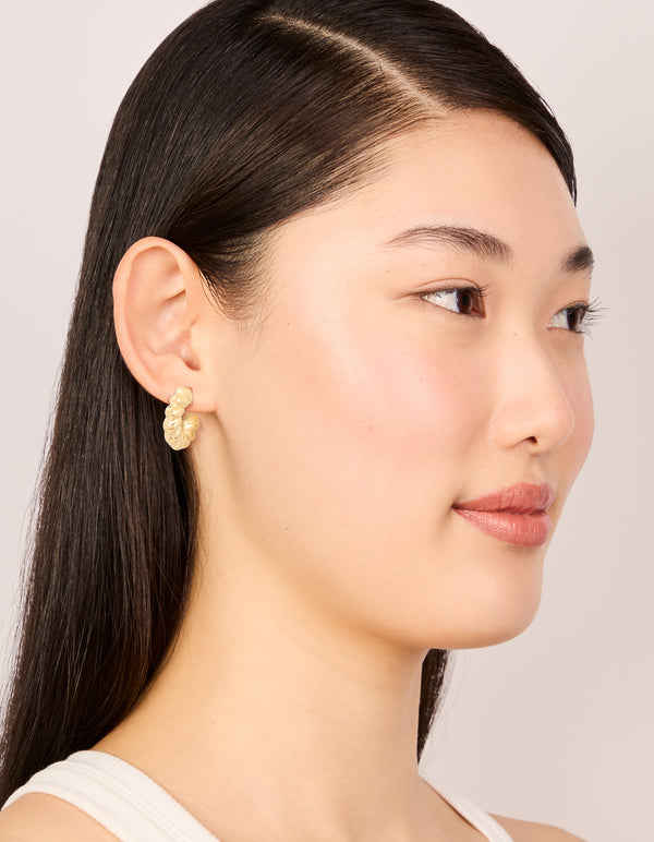Featuring waterproof gold plated stainless steel mini twisted open hoop earrings in gold on model view