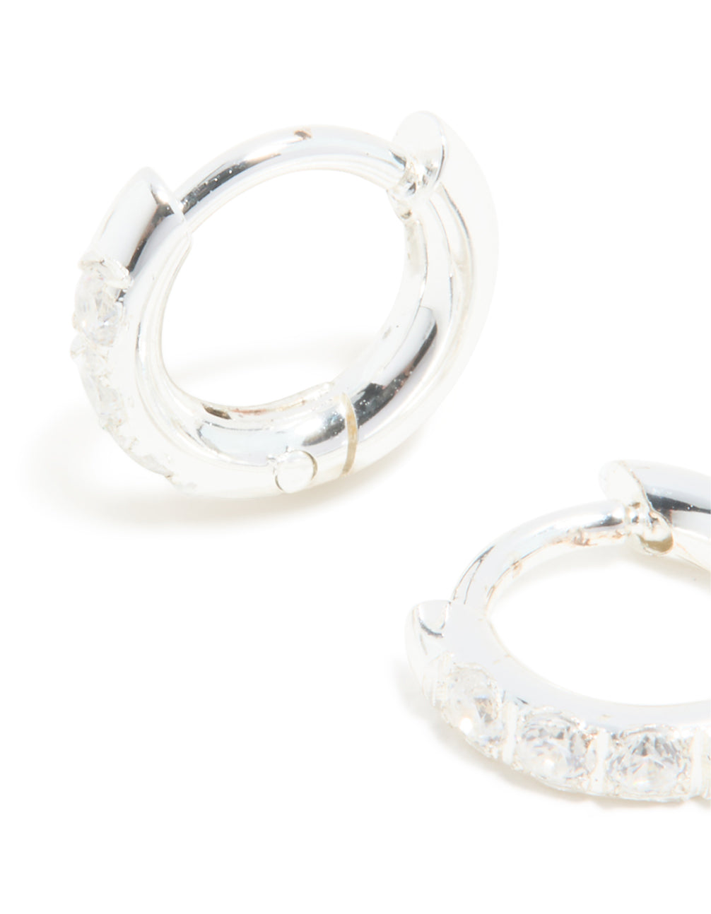 Crafted from waterproof stainless steel with cubic zirconia huggie earrings in silver and clear close up view