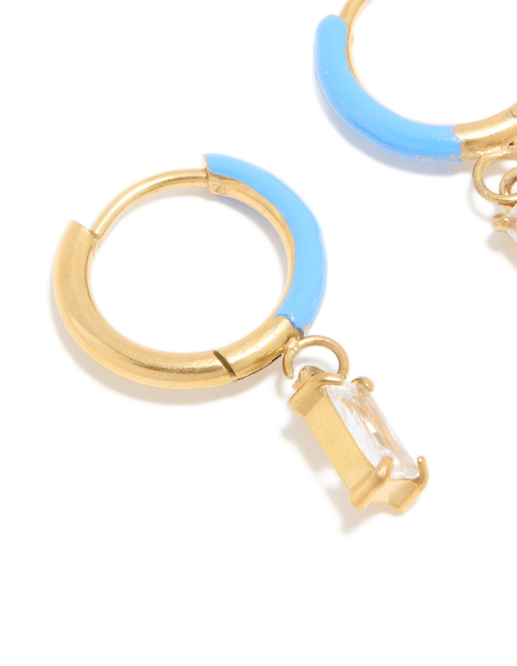 Crafted from waterproof gold plated stainless steel with light blue enamel and crystal charm huggie earrings close up view
