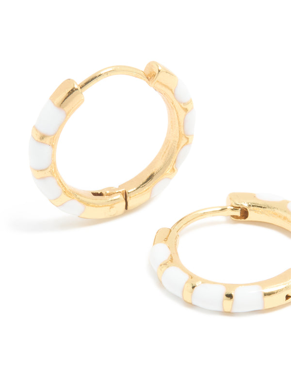 Designed with waterproof gold plated stainless steel white enamel bamboo huggie earrings close up view