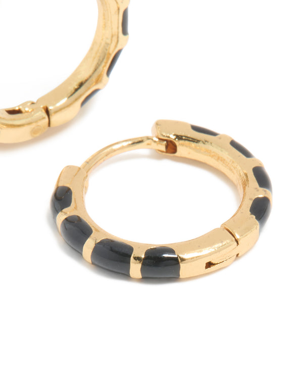 Highlighting the huggie closure and bamboo segments of waterproof gold plated stainless steel black enamel earrings post detail view