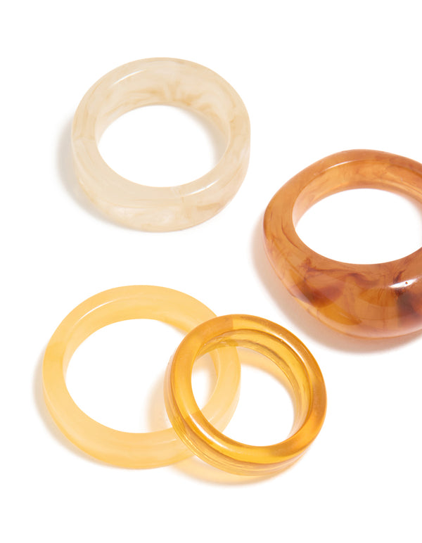 Showcasing chunky statement rings with marble pattern in wheat brown gold and beige, acrylic cigar bubble 6-pack close up view