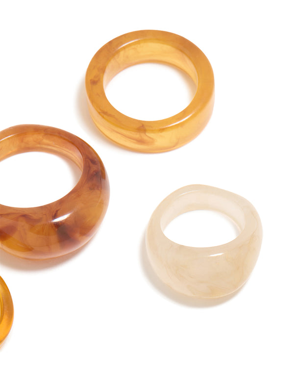 Showcasing chunky statement rings with marble pattern in wheat brown gold and beige, acrylic cigar bubble 6-pack close up view