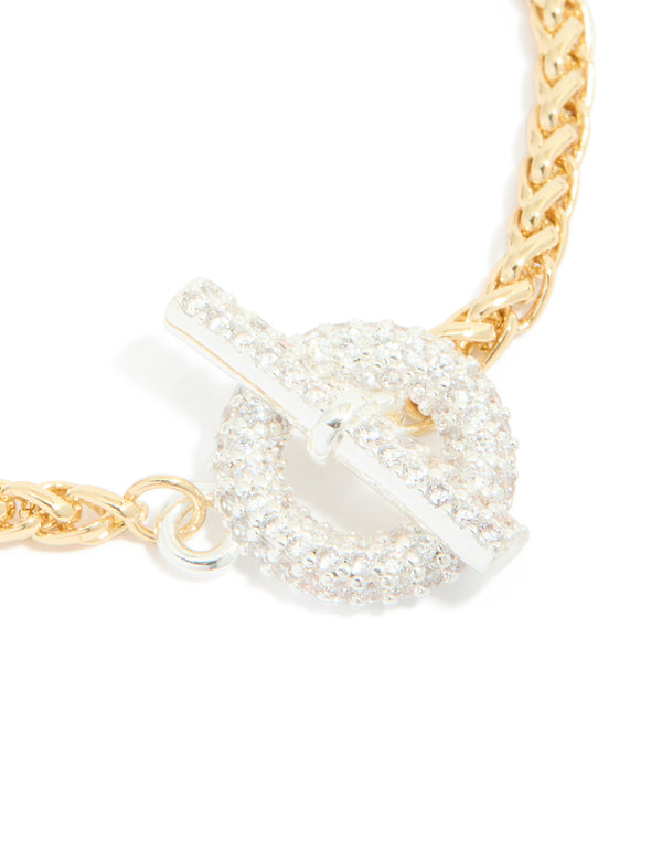 Detailed view of mixed metal plated cubic zirconia T and O chain bracelet highlighting toggle closure and sparkling stones with gold and silver plating close up view