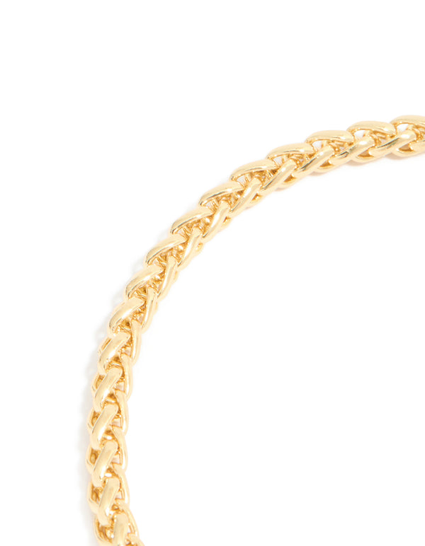 Detailed view of mixed metal plated cubic zirconia T and O chain bracelet highlighting toggle closure and sparkling stones with gold and silver plating close up view