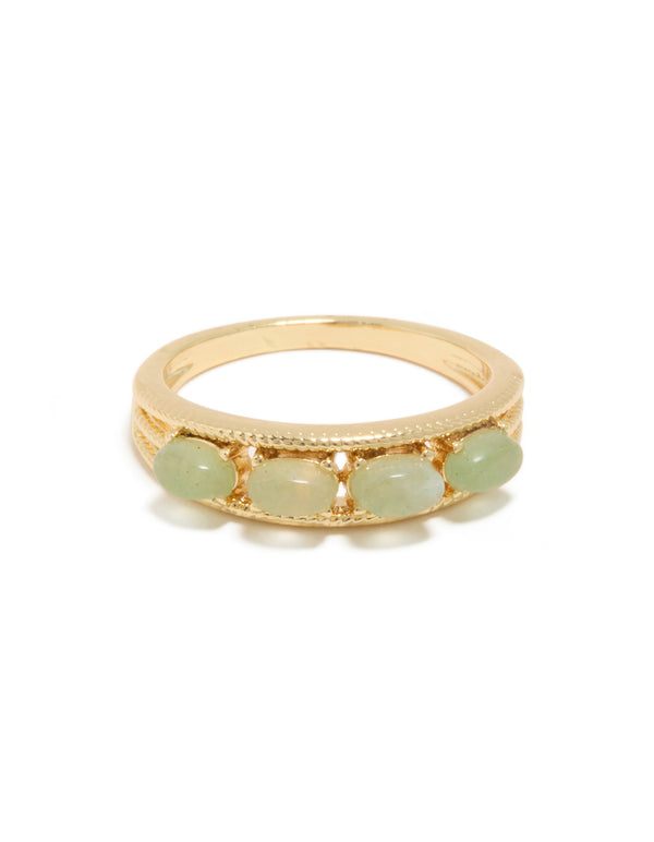 Detailed look at gold plated vintage statement ring with pale green pebbles close up view