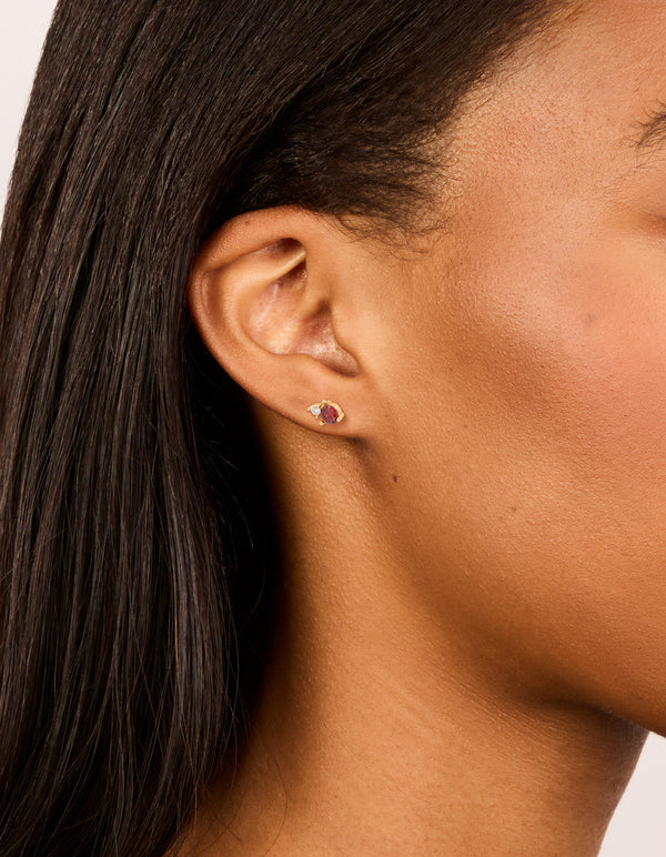 Featuring dainty waterproof stainless steel duo stud earrings with gold plated finish and cubic zirconia stones on ear view