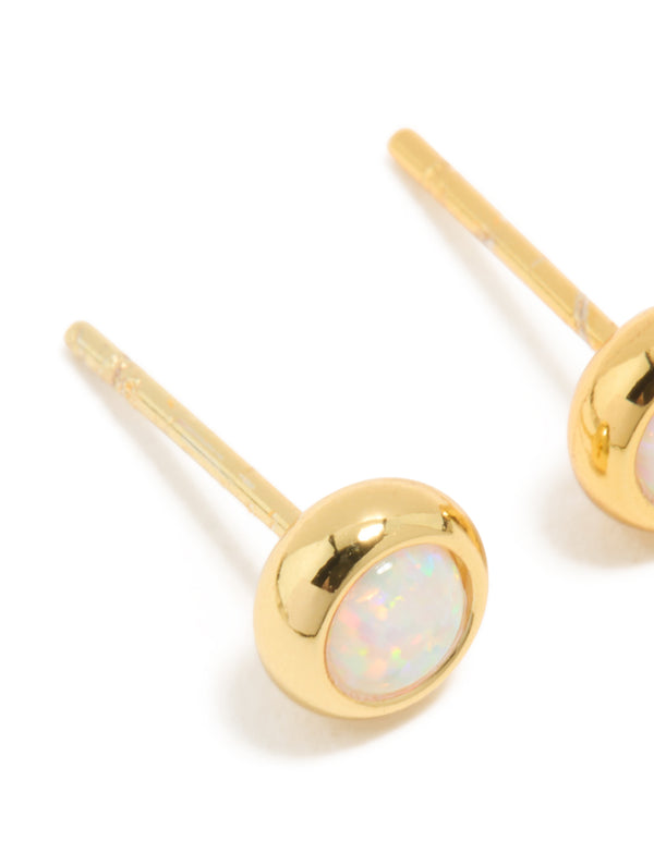 Crafted from waterproof gold plated stainless steel with opal October birthstone bezel set stud design in white close up view