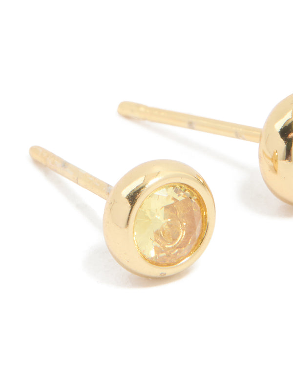 Featuring waterproof bezel set cubic zirconia November birthstone stud earrings in gold plated stainless steel close up view
