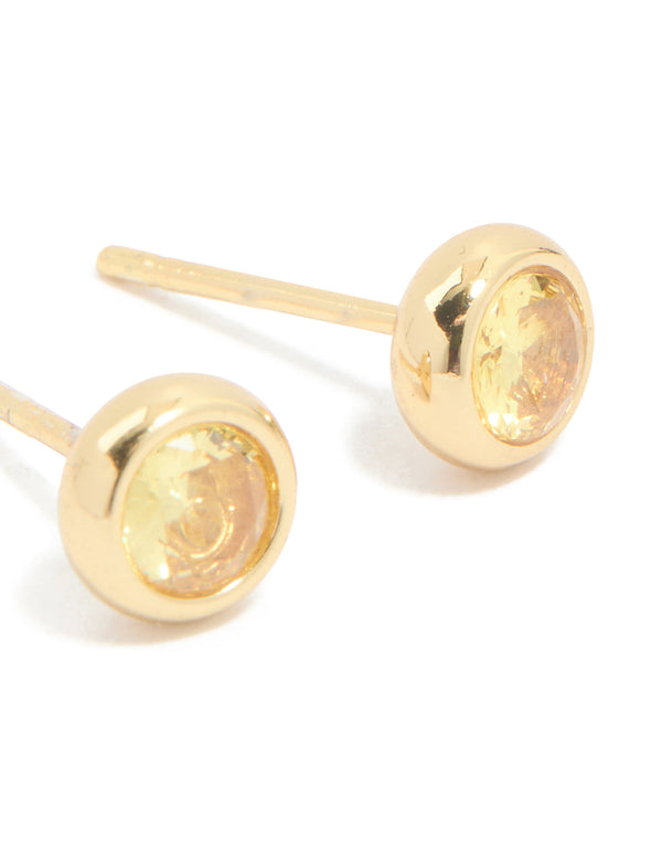 Highlighting waterproof bezel set cubic zirconia November birthstone stud earrings in gold plated stainless steel post detail view