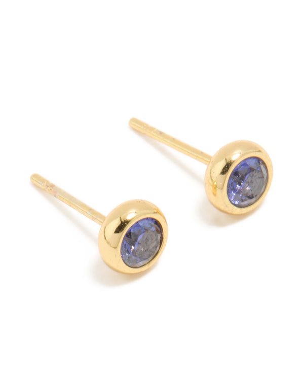 Crafted from waterproof gold plated stainless steel, these tanzanite cubic zirconia December birthstone bezel earrings feature round cut stones and stud closure in royal blue front view