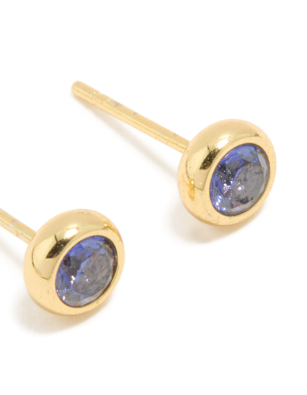 Featuring waterproof gold plated stainless steel construction, these tanzanite cubic zirconia December birthstone bezel earrings with round cut stones and stud closure in royal blue post detail view