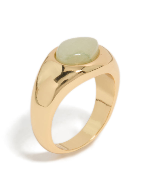 Designed with gold plated material, this ring showcases a pale green oval stone in a statement style close up view