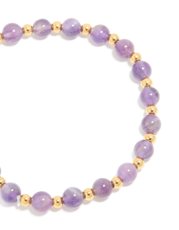 Detailed view of waterproof stretch bracelet featuring beaded amethyst semi precious stone and gold plated stainless steel close up view
