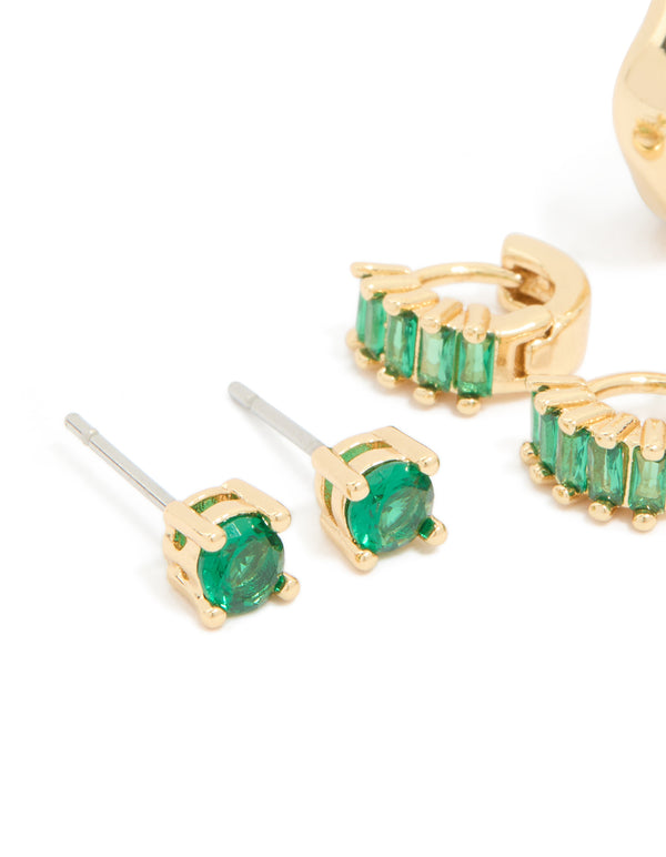 Featuring gold plated brass emerald cubic zirconia huggie and stud earrings in a 4-pack with chunky styling and green crystal detail close up view