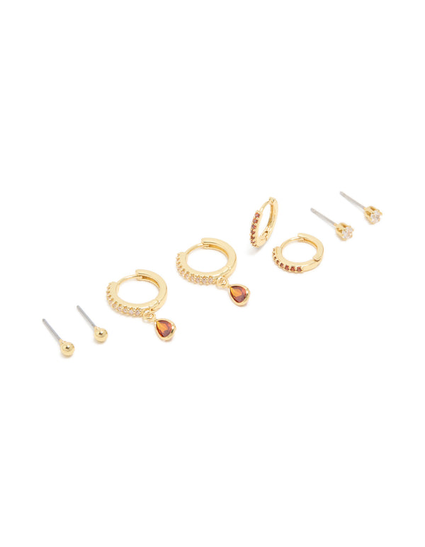 Discover this charm gold plated brass ruby cubic zirconia July birthstone 4-pack earrings featuring crystal with stud, huggie and hoop closures in dark orange and clear front view