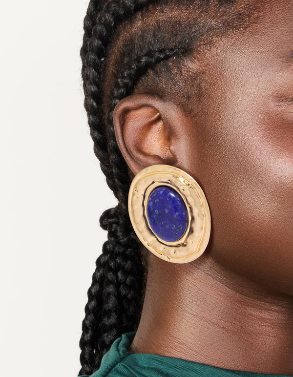 Featuring worn gold round hammered dark blue acrylic stud earrings with statement style on ear view