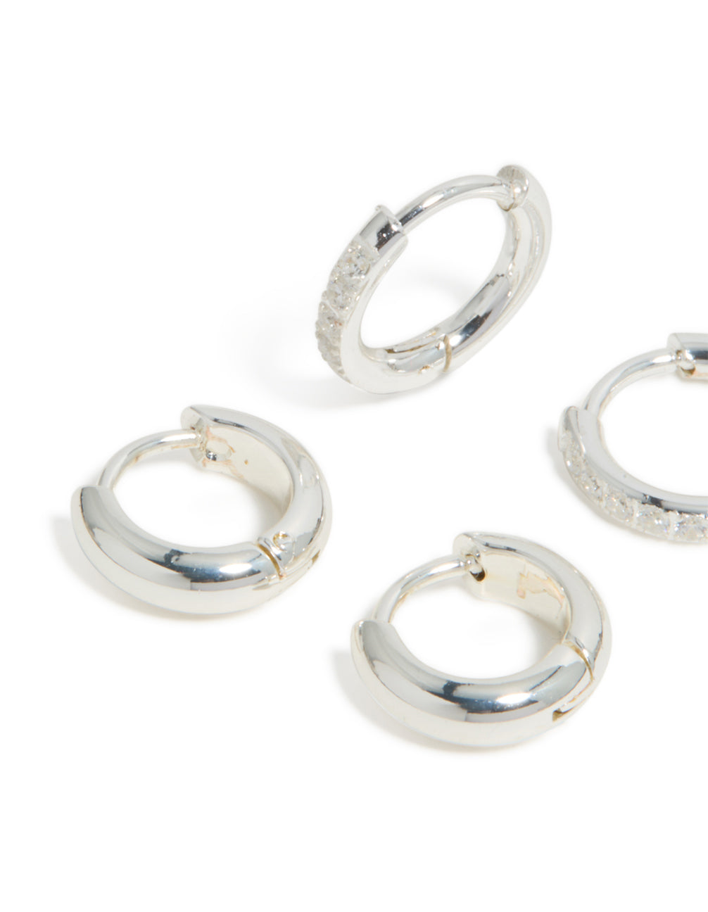 Beautifully crafted waterproof stainless steel pave and plain huggie earrings in a 2-pack with cubic zirconia hoop closure, showcased in silver close up view