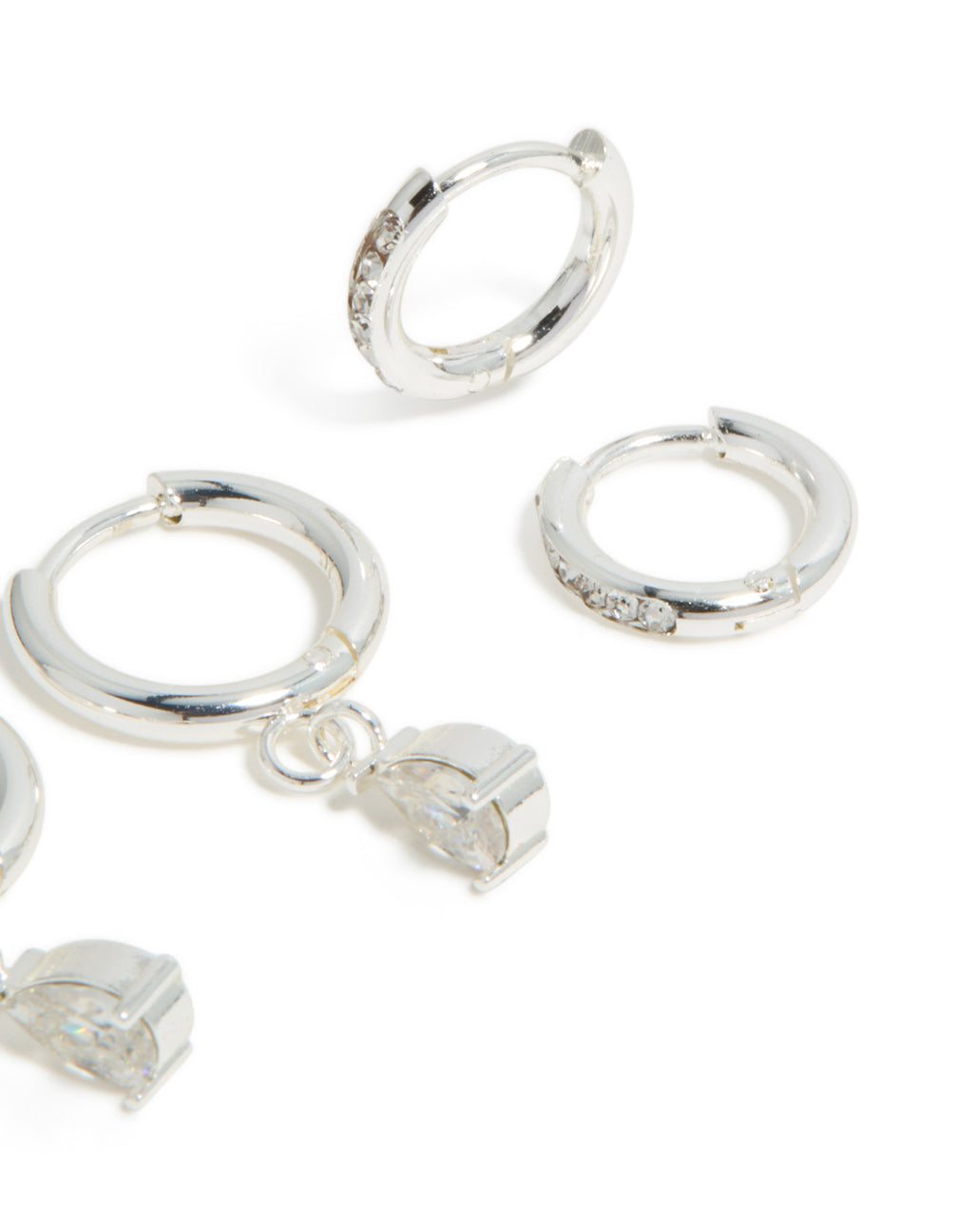 Highlighting waterproof stainless steel cubic zirconia pear and huggie earrings in a 2-pack in silver post detail view