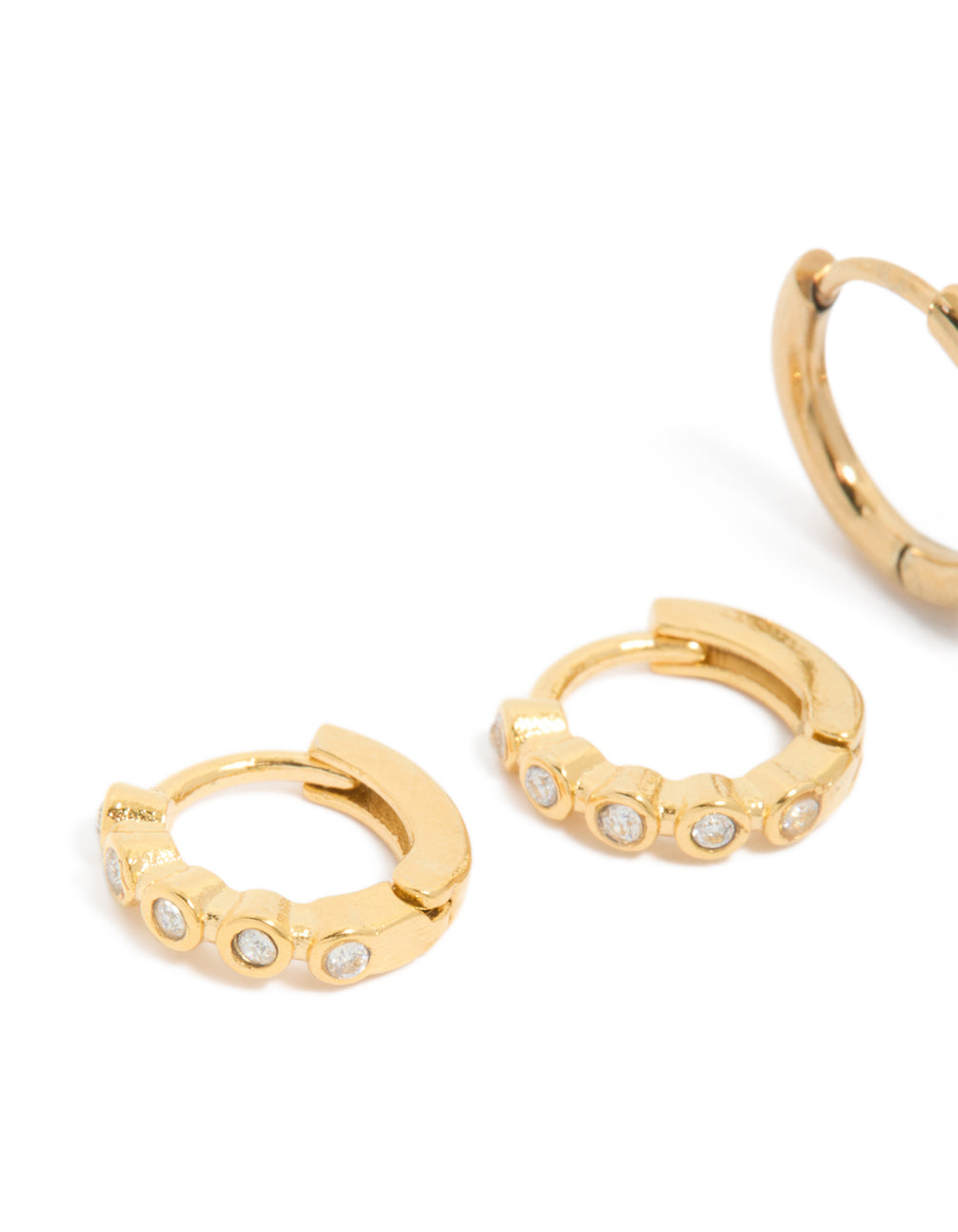 Shop waterproof bezel diamante huggie earrings in a 2-pack, featuring stainless steel construction with gold plating in a close up view